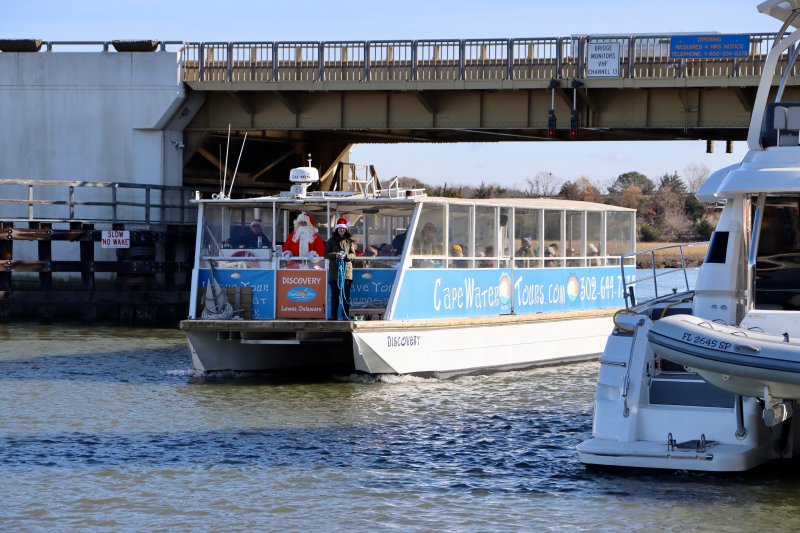 Santa Claus is hard to miss standing on the front of the Cape Water Taxi boat as it approaches the city dock.